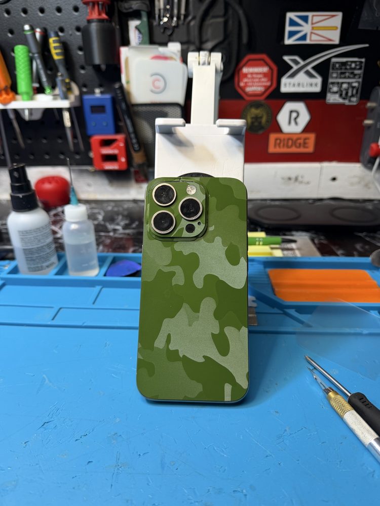 iPhone with a green camo vinyl skin applied