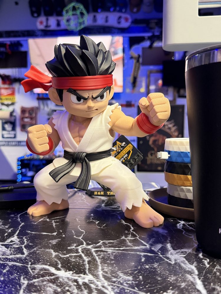 Chibi Ryu figure from Street Fighter in front of a PC